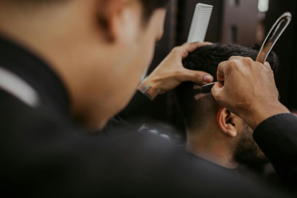 selective focus photography of a barber