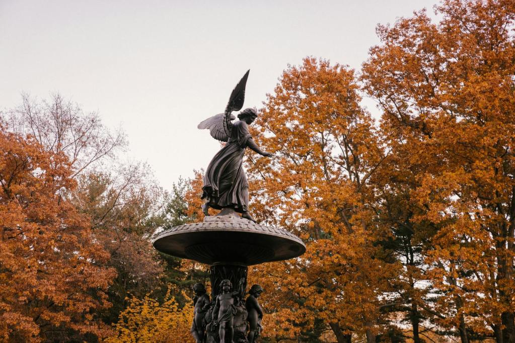 statue of angel in peaceful autumn park