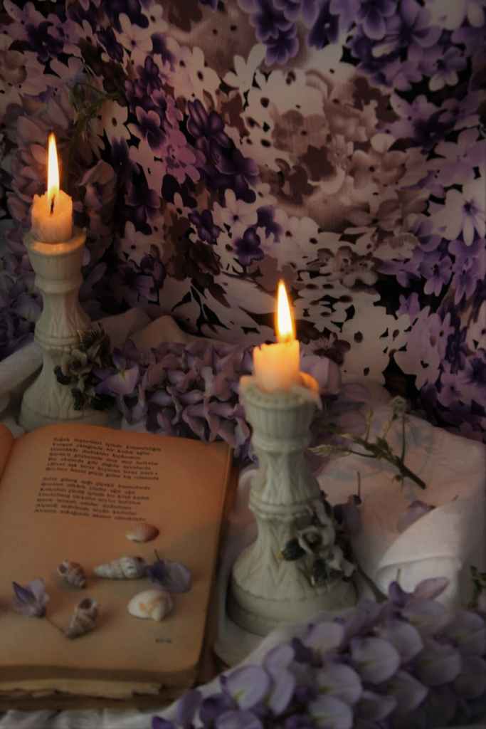 candles by an old book