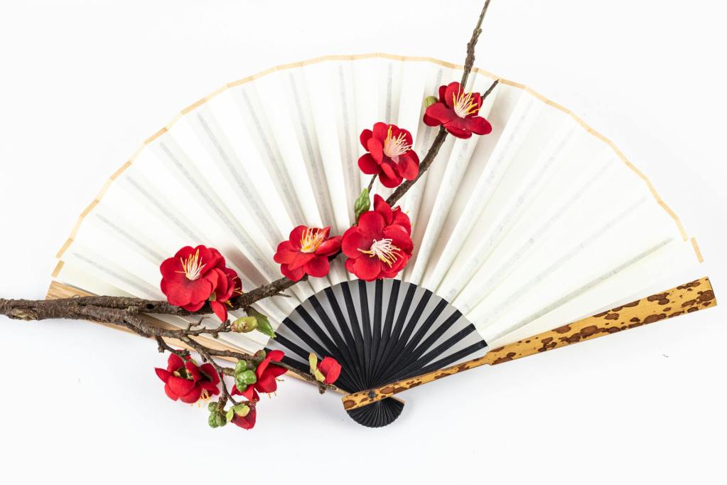 close up shot of a hand fan on a white surface
