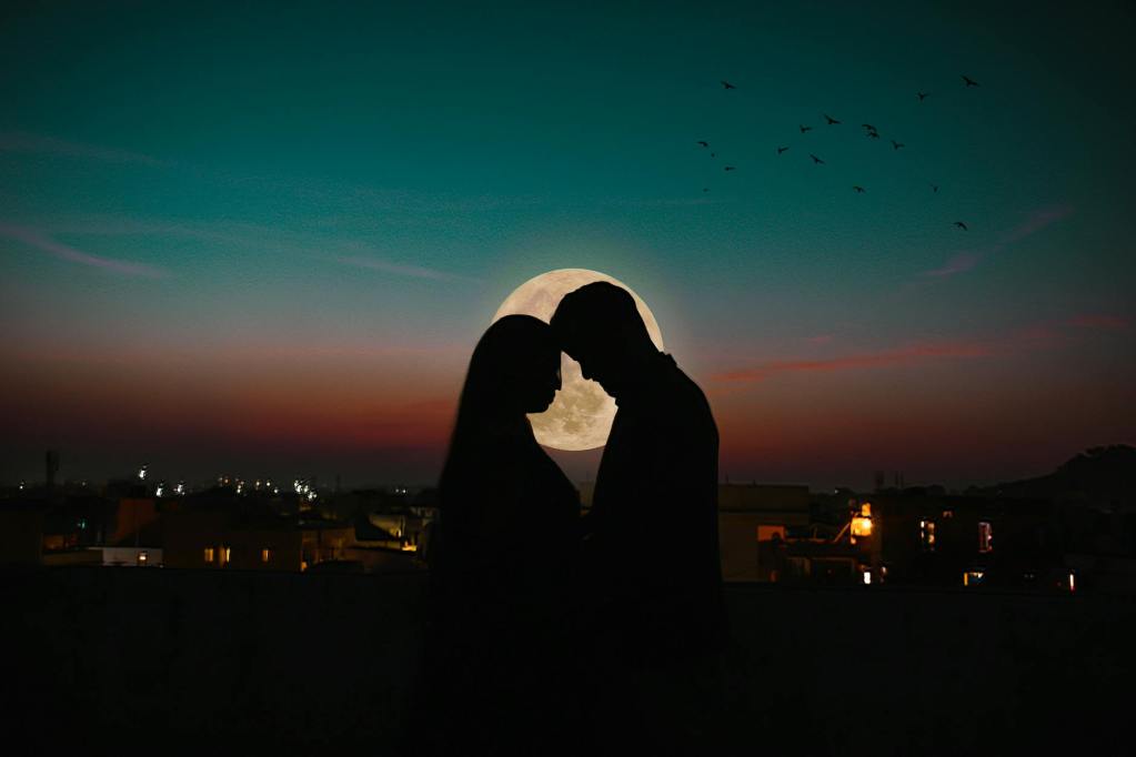 silhouette of a couple standing face to face