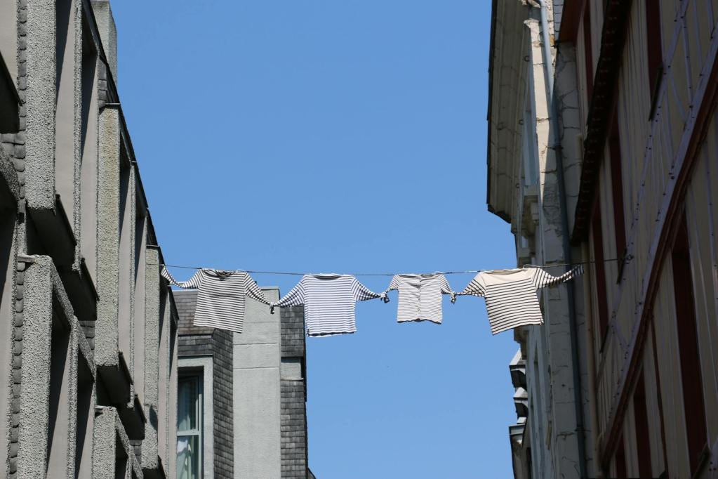 clothes drying on string over alley in town