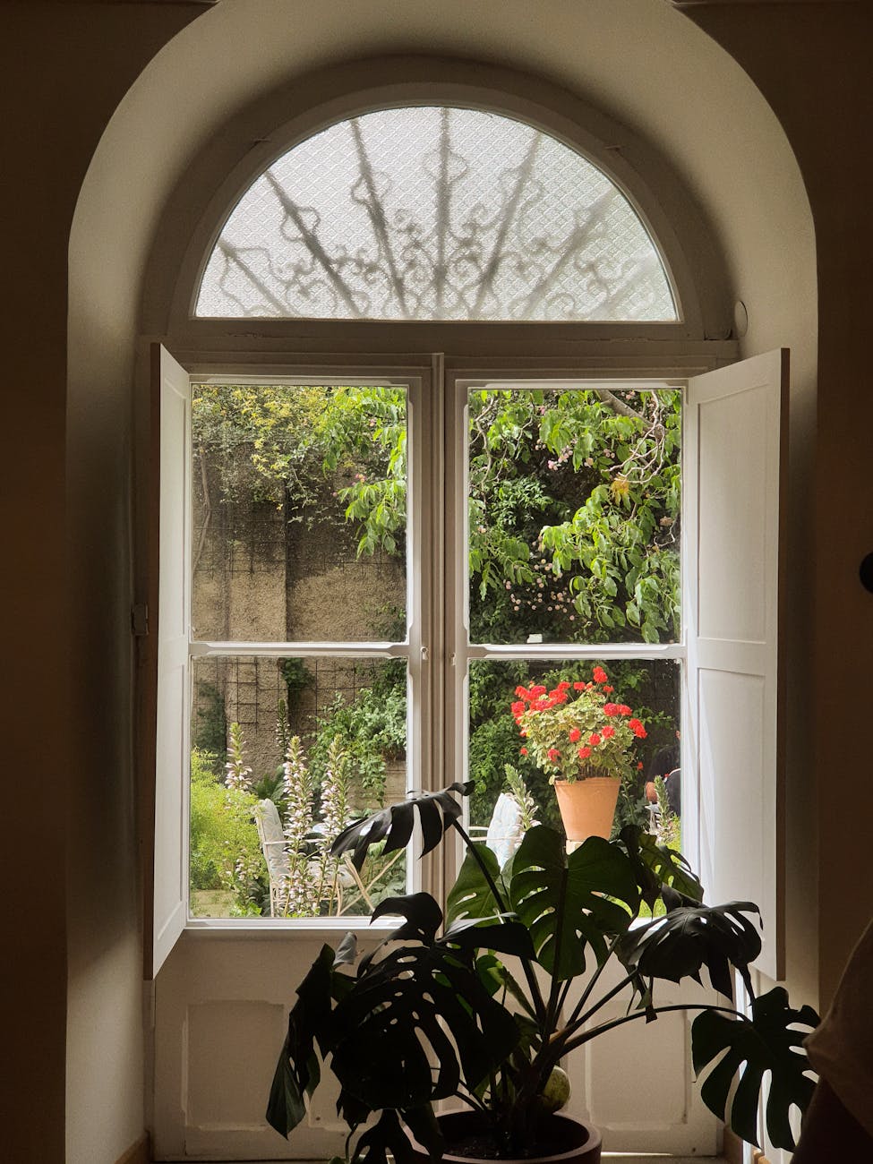 charming garden view through arched window