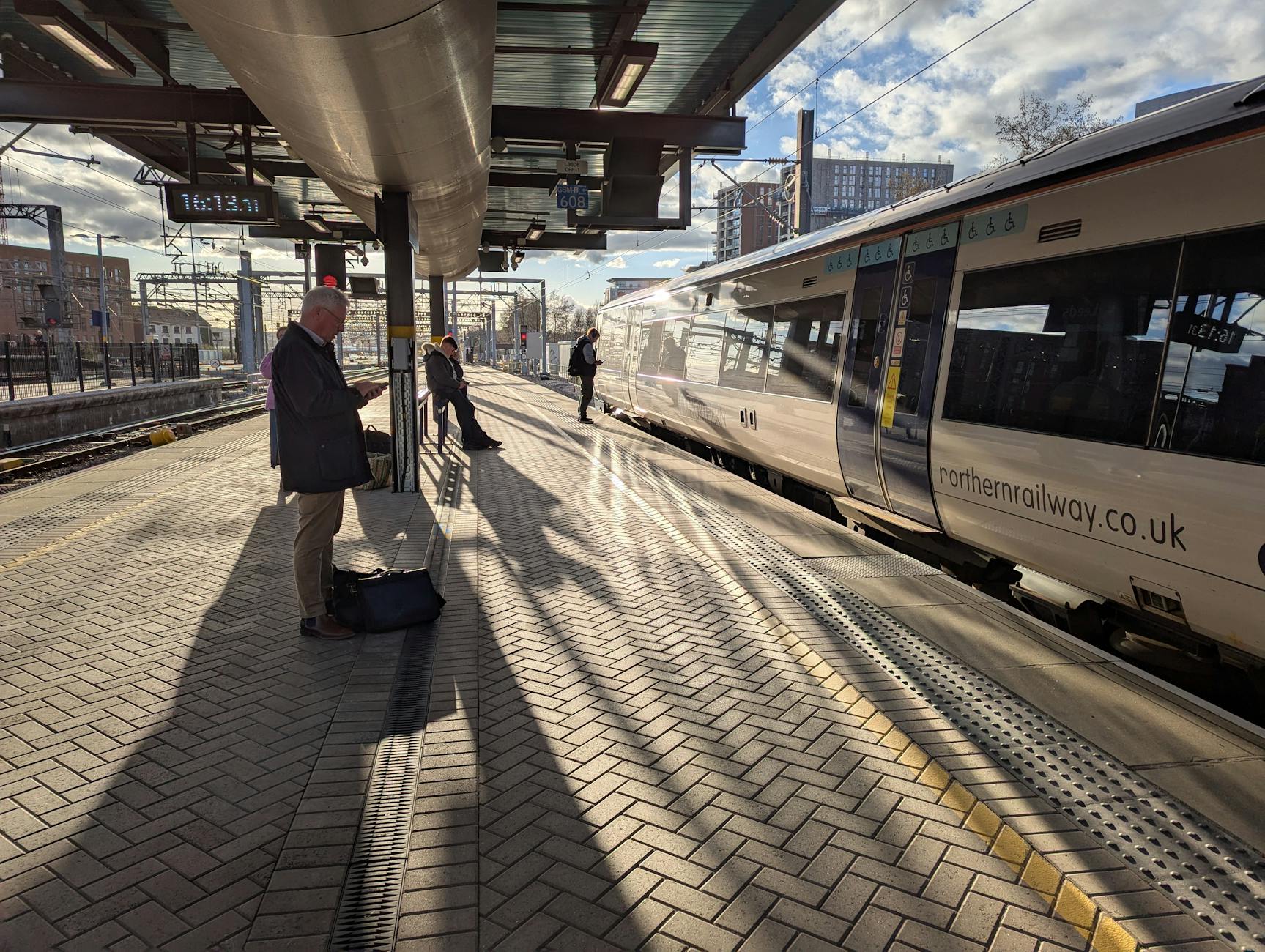 commuters at leeds railway station platform