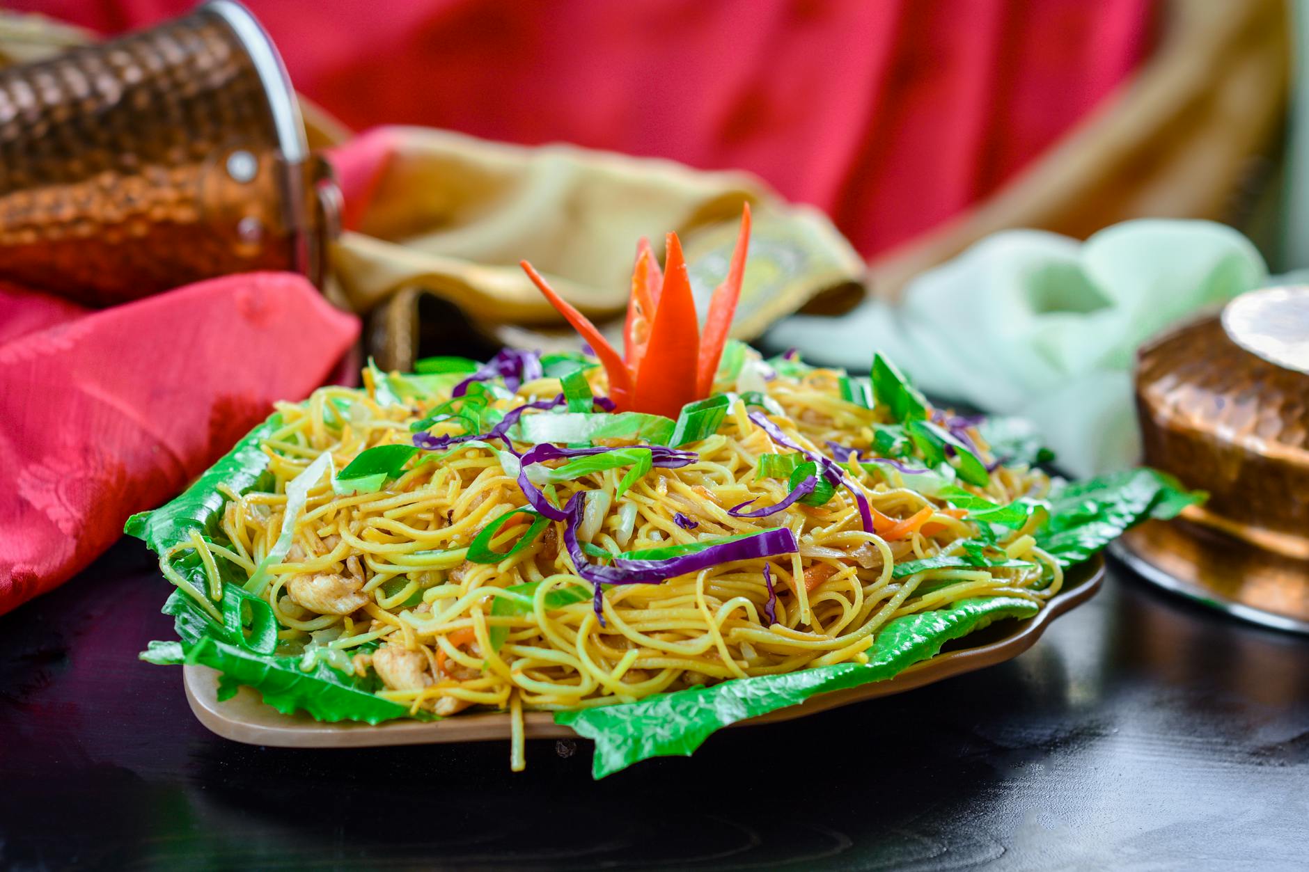 noodle dish over leafy vegetables