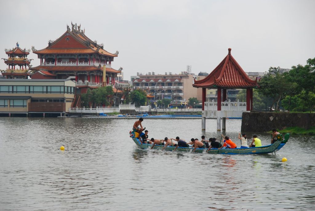 dragon boat race near traditional asian temple