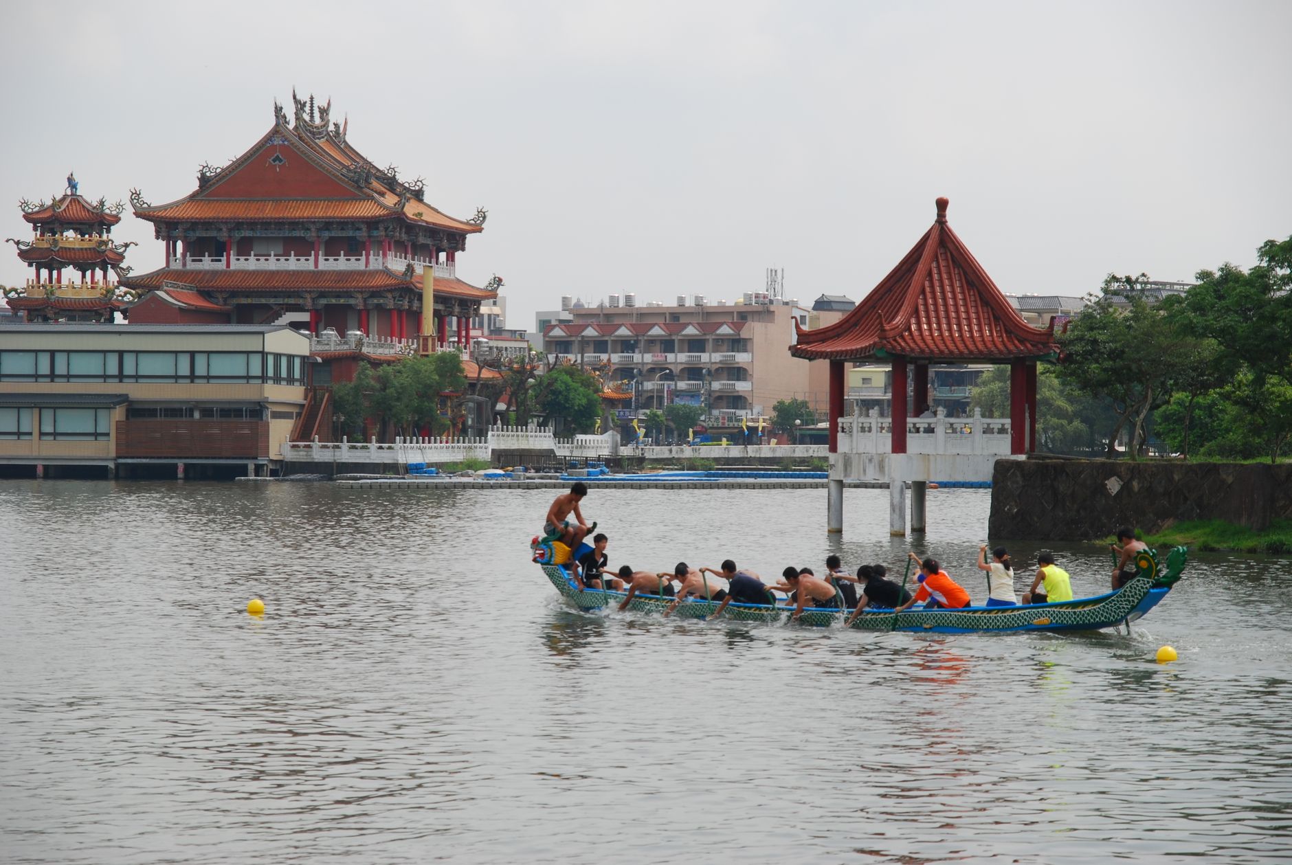 dragon boat race near traditional asian temple