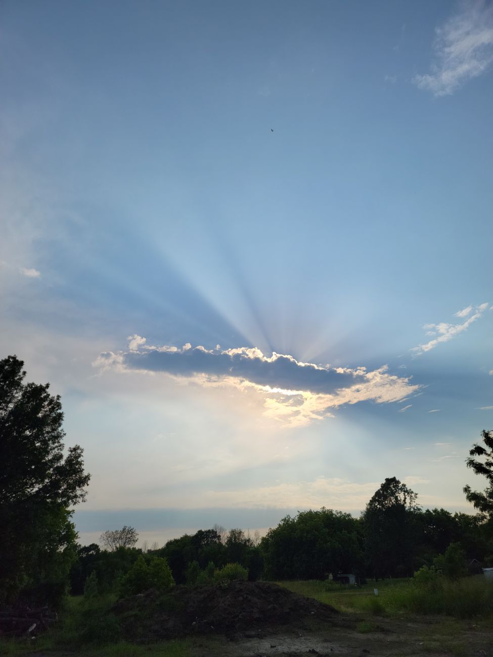 sun hiding behind the clouds in the sky